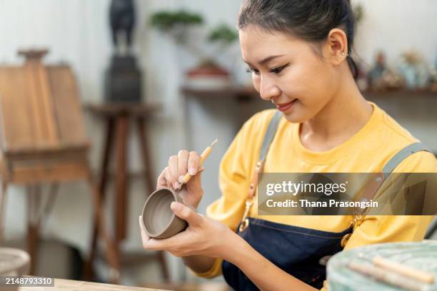 woman making ceramic pots in the ceramic workshop - east asian works of art specialist stock pictures, royalty-free photos & images