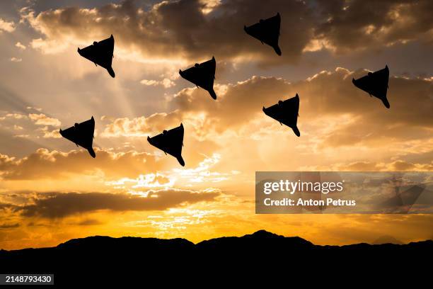 kamikaze drones against the sunset sky - military drone stock pictures, royalty-free photos & images
