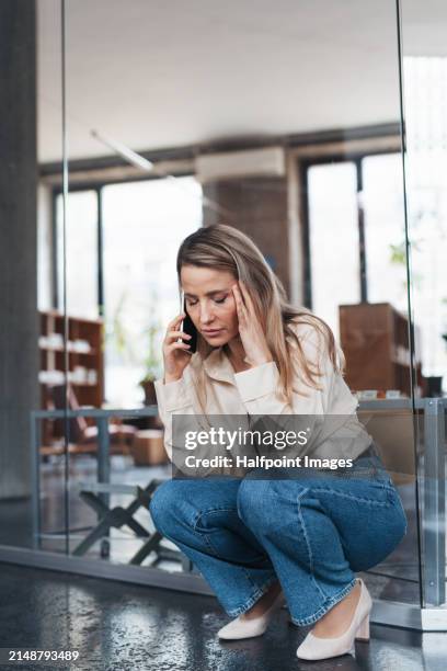 businesswoman is overwhelmed and overworked in her job, burnout syndrome for corporate worker. young female feeling under pressure, lacking personal space. - uncomfortable stock pictures, royalty-free photos & images