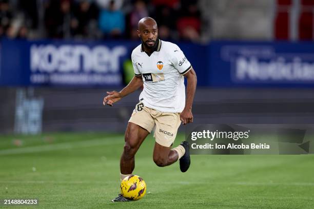 Dimitri Foulquier of Valencia CF with the ball during the LaLiga EA Sports match between CA Osasuna and Valencia CF at Estadio El Sadar on April 15,...