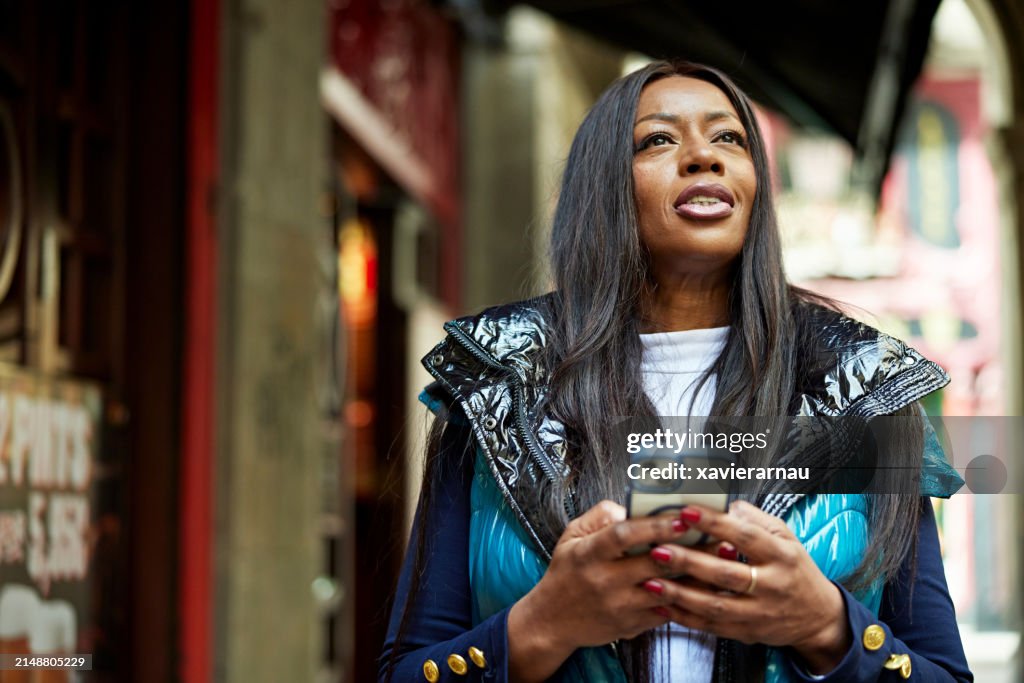 Portrait of mature woman holding smart phone