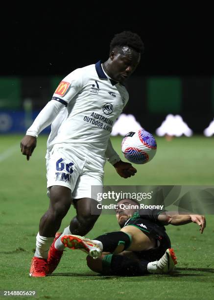 Nestory Irankunda of Adelaide United is tackled by Ben Garuccio of Western United during the A-League Men round 13 match between Western United and...