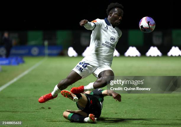 Nestory Irankunda of Adelaide United is tackled by Ben Garuccio of Western United during the A-League Men round 13 match between Western United and...