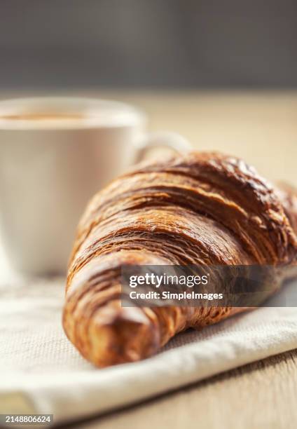 puff pastry croissant with coffee in the background. italian or french breakfast concept. - slovakia country stock pictures, royalty-free photos & images