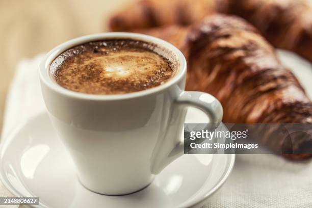 cappuccino and puff pastry croissant in the background. italian or french breakfast concept. - slovakia country stock pictures, royalty-free photos & images