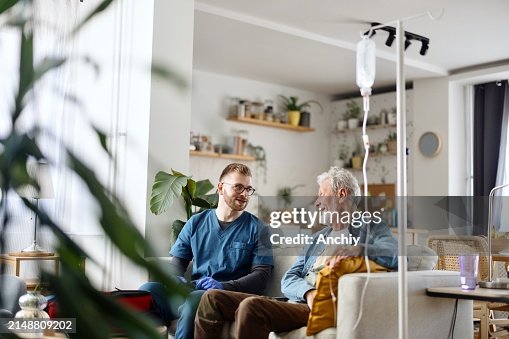 Senior man talking with his caregiver Senior man talking with his caregiver