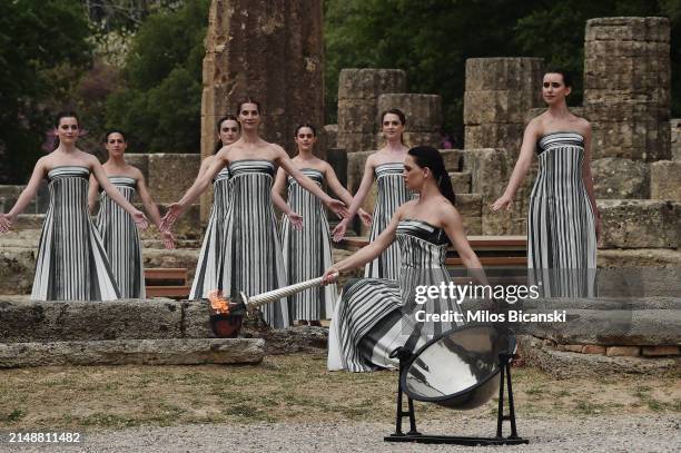 Greek actress Mary Mina, playing the role of the High Priestess, lights the torch during the flame lighting ceremony for the Paris 2024 Summer...