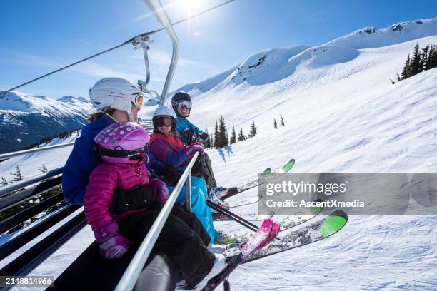ski family ride chairlift together - family skiing stock pictures, royalty-free photos & images