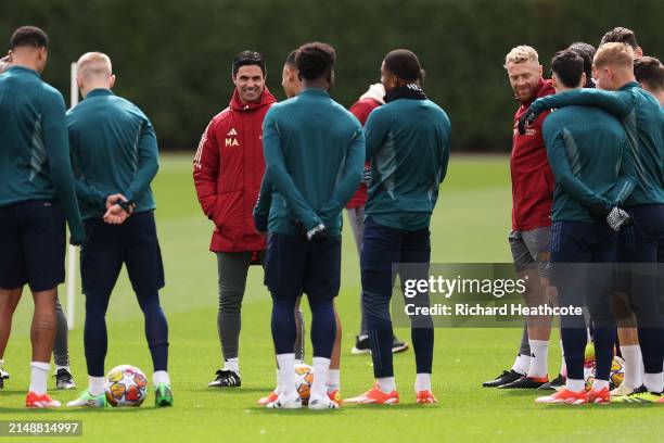 Mikel Arteta, Manager of Arsenal, interacts with his players and staff during a training session at London Colney on April 16, 2024 in St Albans,...