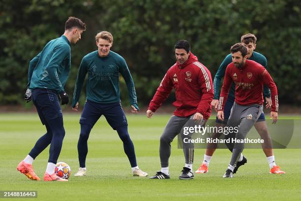 Mikel Arteta, Manager of Arsenal, participates in a training session alongside his players Kai Havertz and Martin Odegaard at London Colney on April...