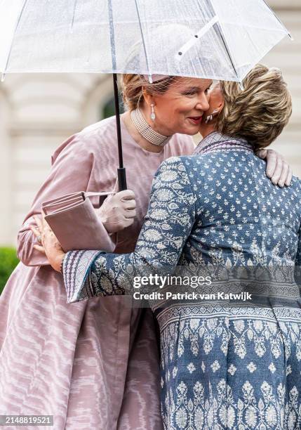 Queen Mathilde of Belgium and Grand Duchess Maria Teresa during an official welcome ceremony at the Royal Palace on April 16, 2024 in Brussels,...