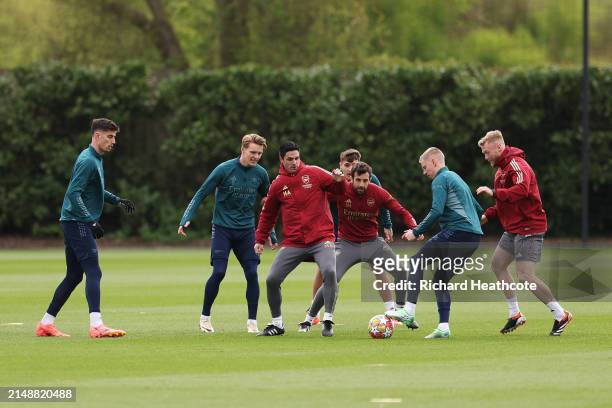 Mikel Arteta, Manager of Arsenal, participates in a training session alongside his players Kai Havertz, Martin Odegaard and Oleksandr Zinchenko at...