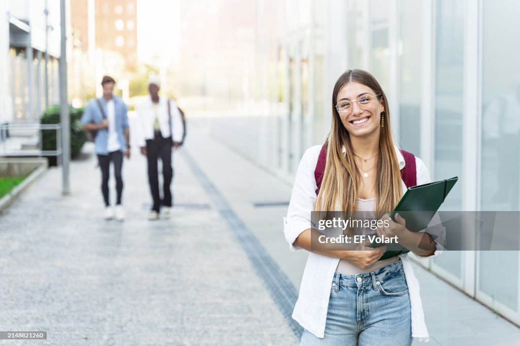 Blond college Student girl smiling ready for classes at the University campus