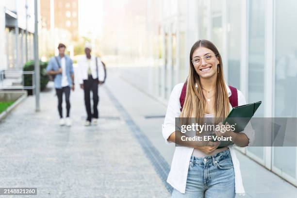 blond college student girl smiling ready for classes at the university campus - scholarship award stock pictures, royalty-free photos & images