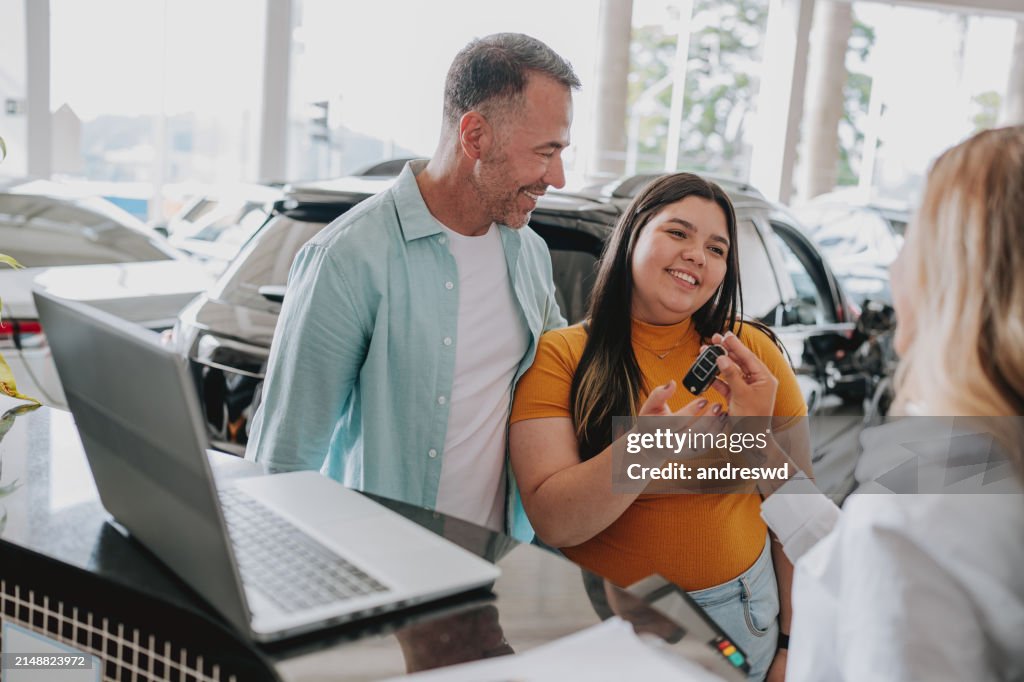 Daughter receiving car keys