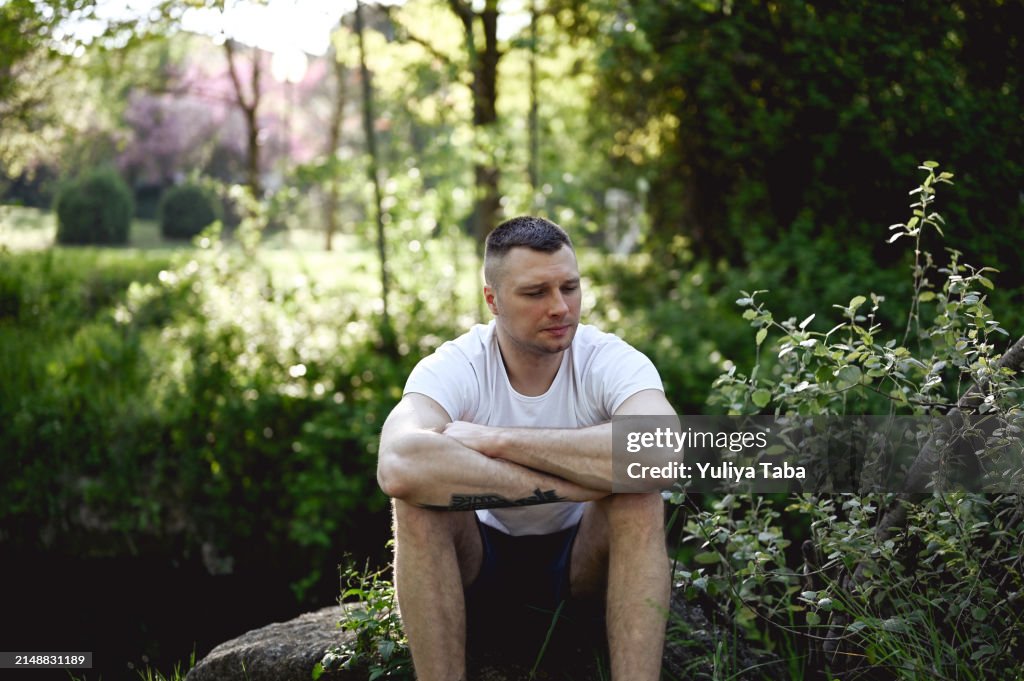 Depressed man in a parkland.