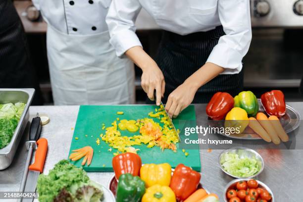 chefs in uniform cutting ingredients while cooking in restaurant kitchen - chopping food stock pictures, royalty-free photos & images