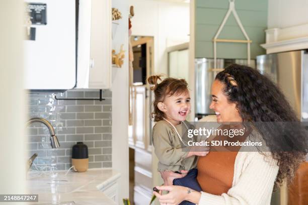 young girl smiles with her mom as they enjoy quality time together - caravan park stock pictures, royalty-free photos & images