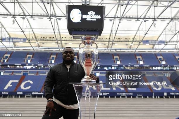 Gerald Asamoah, ambassador of Gelsenkirchen poses with the official EURO 2024 trophy at the Arena during the UEFA Euro 2024 Trophy Tour on April 16,...