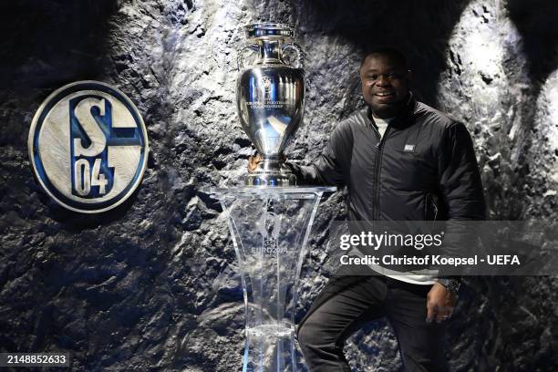 Gerald Asamoah, ambassador of city host Gelsenkirchen poses with the UEFA EURO 2024 Trophy at the Arena on April 16, 2024 in Gelsenkirchen, Germany.