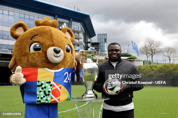 Gerald Asamoah, ambassador of Gelsenkirchen city host poses with Albärt, offical UEFA EURO 2024 mascot and the UEFA EURO 2024 Trophy at Arena on...