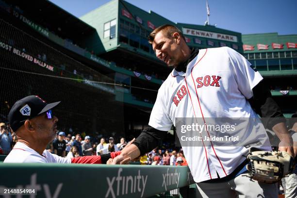 Boston Red Sox manager Alex Cora of the Boston Red Sox, left, and Rob Gronkowski, former NFL player for the New England Patriots talk before a game...