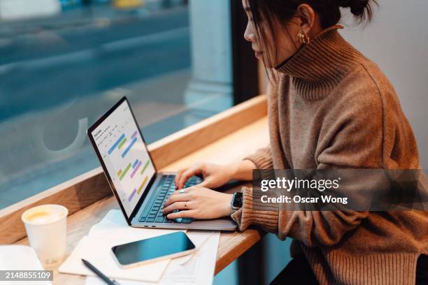 young asian businesswoman working with laptop at cafe - e learning stock pictures, royalty-free photos & images
