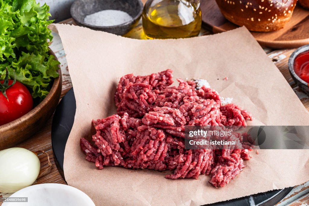 Organic raw ground beef and burger ingredients, cooking preparation