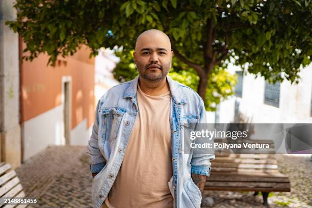 bald man looking at camera outdoors - gay man stock pictures, royalty-free photos & images