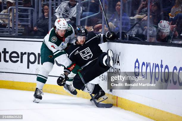 Brock Faber of the Minnesota Wild checks Viktor Arvidsson of the Los Angeles Kings in the second period at Crypto.com Arena on April 15, 2024 in Los...