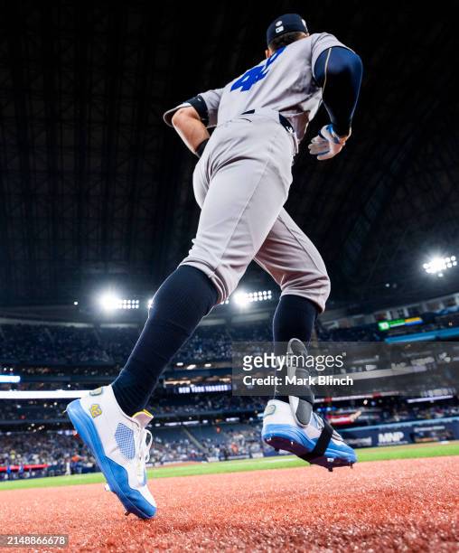 Aaron Judge of the New York Yankees takes the field wearing cleats with the number 42 on them in honor of Jackie Robinson day ahead of playing...