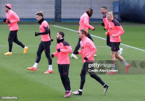 Bernardo Silva and Kevin De Bruyne of Manchester City alongside teammates Jack Grealish and Erling Haaland during a training session at Manchester...