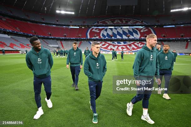 Eddie Nketiah, Leandro Trossard and Emile Smith Rowe of Arsenal on the pitch at the Allianz Arena on April 16, 2024 in Munich, Germany.