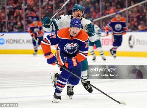 Warren Foegele of the Edmonton Oilers skates against Mario Ferraro of the San Jose Sharks during the game at Rogers Place on April 15 in Edmonton,...