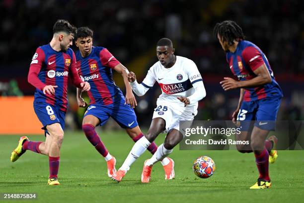 Nuno Mendes of Paris Saint-Germain battles for possession with Pedri, Lamine Yamal and Jules Kounde of FC Barcelona during the UEFA Champions League...