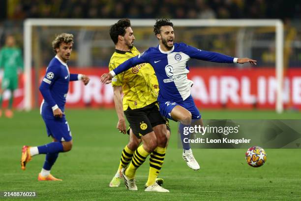 Mario Hermoso of Atletico Madrid is challenged by Mats Hummels of Borussia Dortmund during the UEFA Champions League quarter-final second leg match...