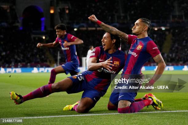 Raphinha of FC Barcelona celebrates scoring his team's first goal with teammate Jules Kounde during the UEFA Champions League quarter-final second...