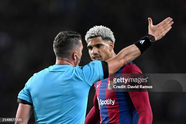 Ronald Araujo of FC Barcelona reacts towards Referee Istvan Kovacs as he is ushered off after being shown a red card following a foul on Bradley...