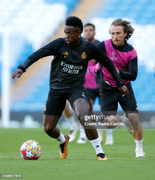 Vinicius Junior and Luka Modric players of Real Madrid are training at Etihad Stadium on April 16, 2024 in Manchester, England.