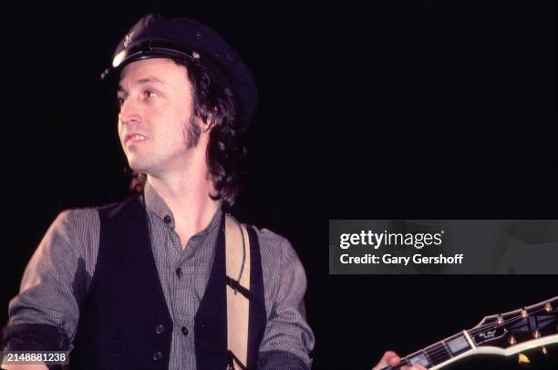 American musician Mike Campbell, of the group Tom Petty and the Heartbreakers, plays guitar as he performs onstage during the 'Long After Dark' tour...