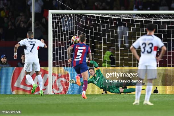 Marc-Andre ter Stegen of FC Barcelona fails to save a penalty kick from Kylian Mbappe of Paris Saint-Germain, resulting in Paris Saint-Germain's...