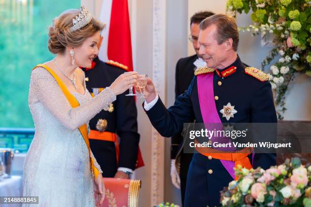 Queen Mathilde of Belgium and Grand Duke Henri of Luxembourg bring out a toast during a gala dinner at the Royal Castle of Laeken on April 16, 2024...