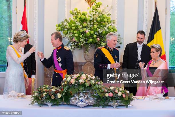 King Philippe and Queen Mathilde of Belgium bring out a toast with Grand Duke Henri and Grand Duchesse Maria Teresa of Luxembourg during a gala...