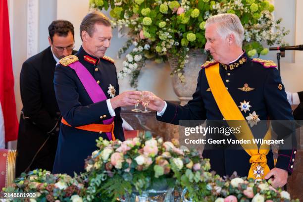 King Philippe of Belgium and Grand Duke Henri of Luxembourg bring out a toast during a gala dinner at the Royal Castle of Laeken on April 16, 2024 in...