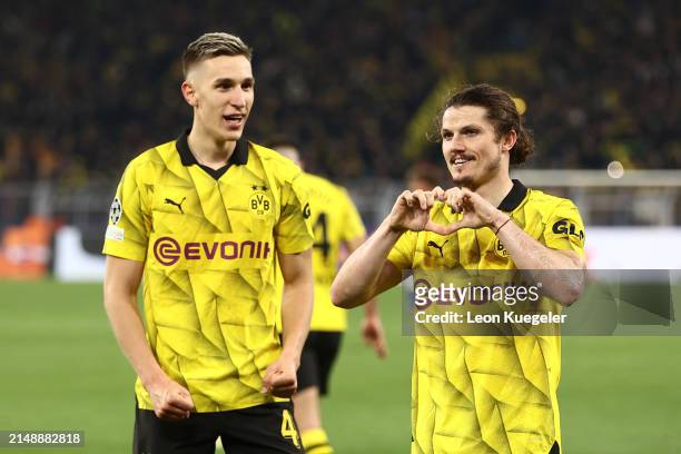 Marcel Sabitzer of Borussia Dortmund celebrates scoring his team's fourth goal with teammate Nico Schlotterbeck during the UEFA Champions League...