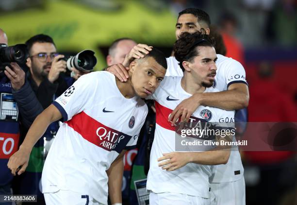 Kylian Mbappe of Paris Saint-Germain celebrates scoring his team's third goal from a penalty kick with teammate Vitinha during the UEFA Champions...