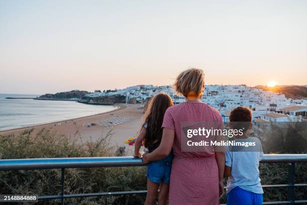 family standing on a view point and enjoys summer vacation - family algarve stock pictures, royalty-free photos & images