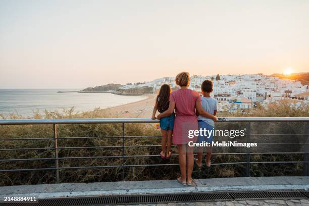 family standing on a view point and enjoys summer vacation - family algarve stock pictures, royalty-free photos & images