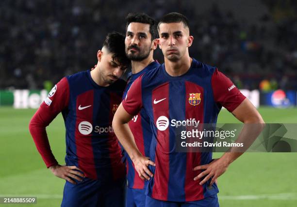 Pedri, Ilkay Guendogan and Ferran Torres of FC Barcelona look dejected after the team's defeat in the UEFA Champions League quarter-final second leg...