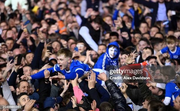 Paddy Lane of Portsmouth crowd surfs as fans invade the pitch after becoming Sky Bet League One champions during the Sky Bet League One match between...